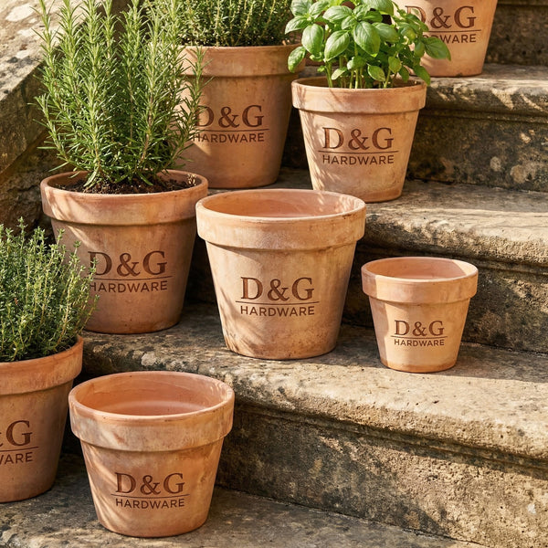 Terracotta pots with 'D&G Hardware' branding on stone steps.